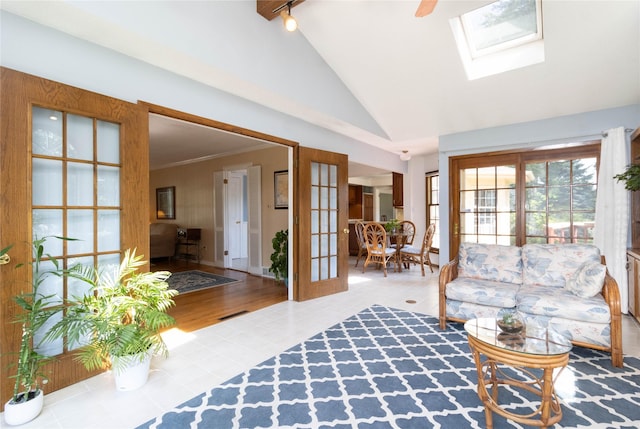 1809 79th St, Windsor Heights, IA 50324 - living area featuring rail lighting, a skylight, and high vaulted ceiling