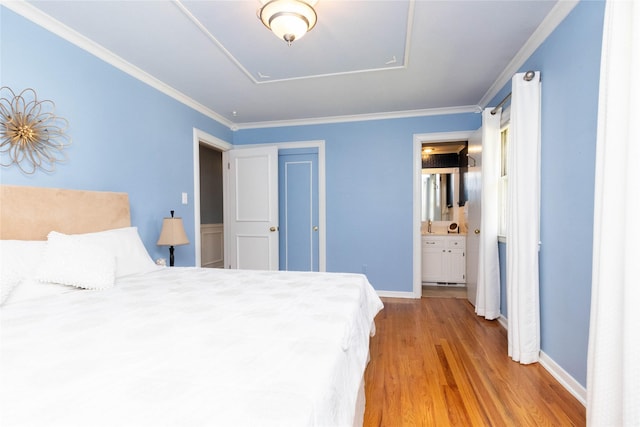 1809 79th St, Windsor Heights, IA 50324 - bedroom featuring wood finished floors, ensuite bath, a closet, and crown molding