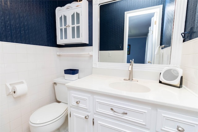1809 79th St, Windsor Heights, IA 50324 - bathroom featuring tile walls, vanity, wallpapered walls, and a wainscoted wall