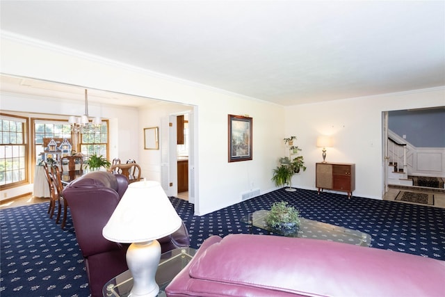 1809 79th St, Windsor Heights, IA 50324 - living area with ornamental molding, stairs, carpet flooring, and a chandelier