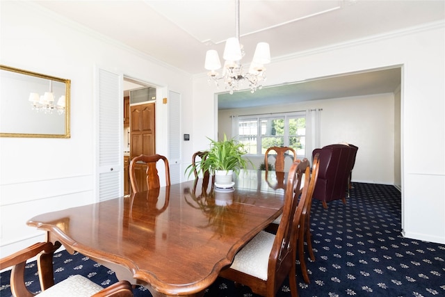 1809 79th St, Windsor Heights, IA 50324 - dining space featuring a chandelier, crown molding, and dark colored carpet