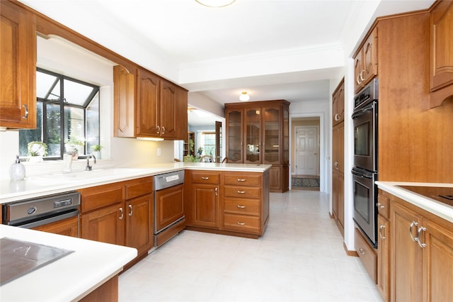 1809 79th St, Windsor Heights, IA 50324 - kitchen featuring dishwasher, double oven, brown cabinets, black electric stovetop, and crown molding