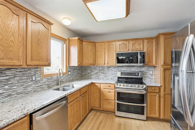 4380 Ashley Park Dr, West Des Moines, IA 50265 - kitchen with stainless steel appliances, light wood finished floors, tasteful backsplash, and light stone counters