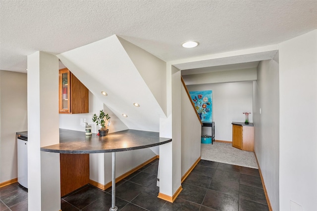 4380 Ashley Park Dr, West Des Moines, IA 50265 - hallway featuring a textured ceiling, dark tile patterned floors, and recessed lighting