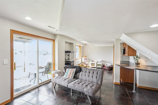 4380 Ashley Park Dr, West Des Moines, IA 50265 - living room with a textured ceiling, recessed lighting, dark tile patterned floors, and stairway