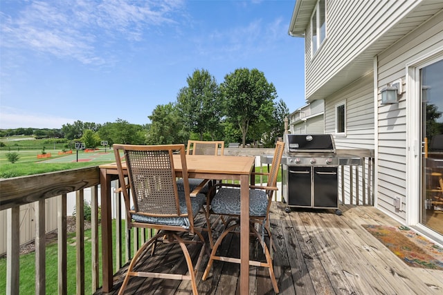 4380 Ashley Park Dr, West Des Moines, IA 50265 - wooden terrace featuring grilling area, outdoor dining area, and view of scattered trees