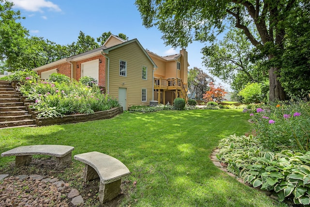 904 54th St, West Des Moines, IA 50266 - view of green lawn with a garage and stairway