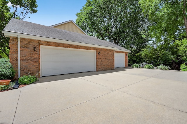 904 54th St, West Des Moines, IA 50266 - garage featuring concrete driveway