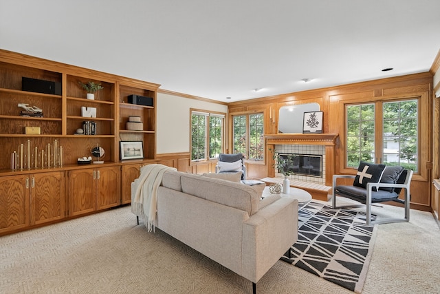 904 54th St, West Des Moines, IA 50266 - living area with ornamental molding, light carpet, plenty of natural light, a tile fireplace, and a decorative wall