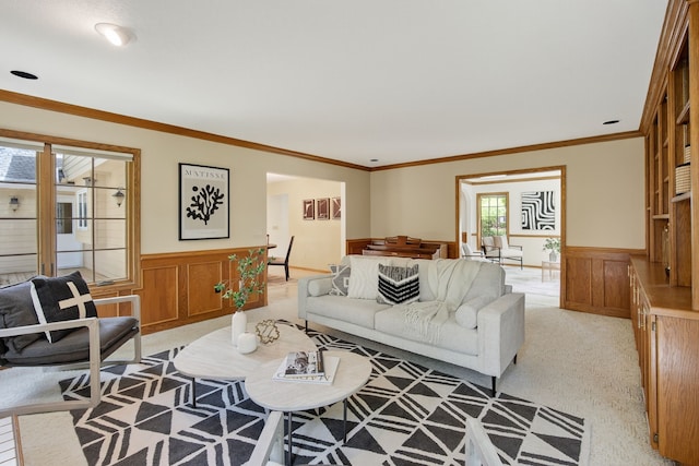 904 54th St, West Des Moines, IA 50266 - living room featuring a wainscoted wall, light carpet, crown molding, and a decorative wall