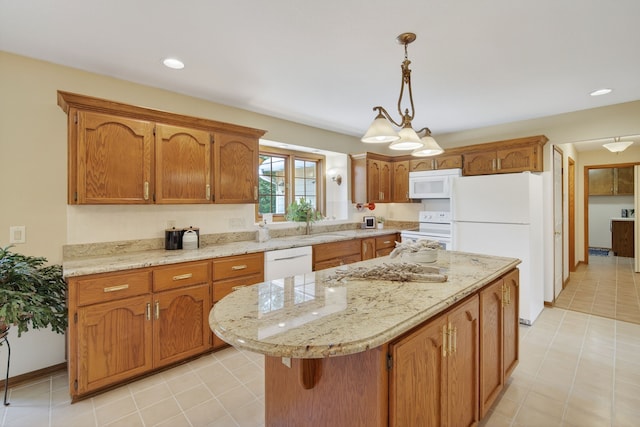 904 54th St, West Des Moines, IA 50266 - kitchen with white appliances, brown cabinetry, a kitchen island, decorative light fixtures, and light tile patterned floors