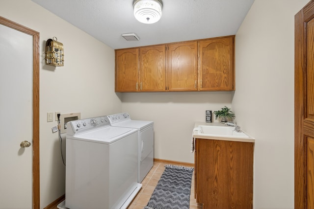 904 54th St, West Des Moines, IA 50266 - laundry area featuring independent washer and dryer, cabinet space, and light tile patterned floors