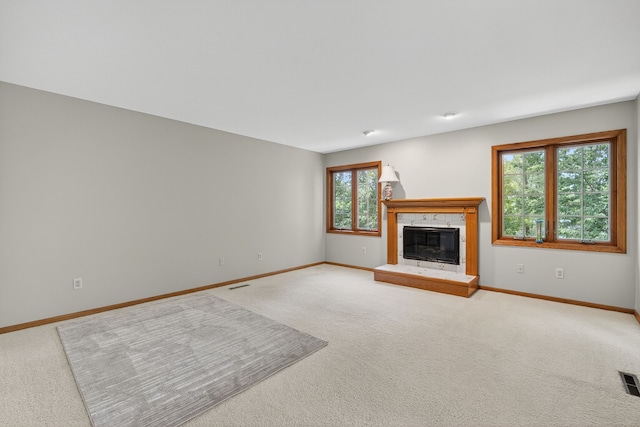 904 54th St, West Des Moines, IA 50266 - unfurnished living room with light carpet and a tiled fireplace