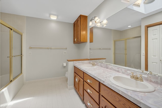 904 54th St, West Des Moines, IA 50266 - bathroom featuring double vanity, a skylight, tile patterned flooring, and enclosed tub / shower combo