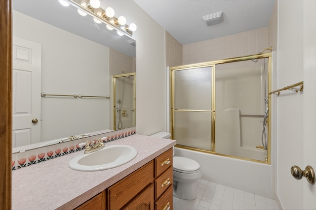 904 54th St, West Des Moines, IA 50266 - bathroom with vanity, tile patterned floors, and combined bath / shower with glass door