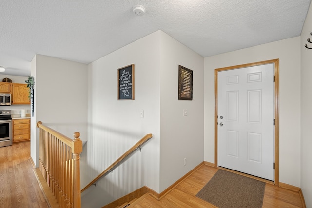 2618 13th St SW, Altoona, IA 50009 - entryway featuring light wood-type flooring and a textured ceiling