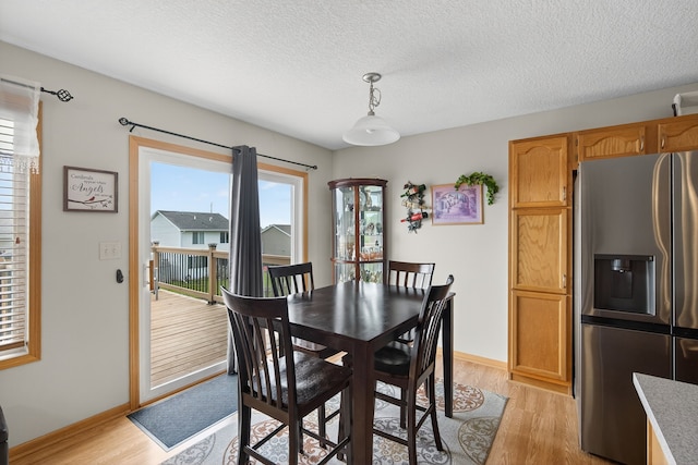 2618 13th St SW, Altoona, IA 50009 - dining room featuring light wood-style floors and a textured ceiling