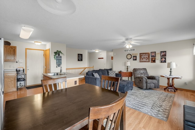 2618 13th St SW, Altoona, IA 50009 - dining room featuring ceiling fan and light wood-type flooring