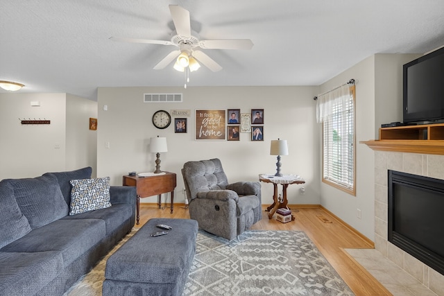 2618 13th St SW, Altoona, IA 50009 - living room with wood finished floors, ceiling fan, and a fireplace