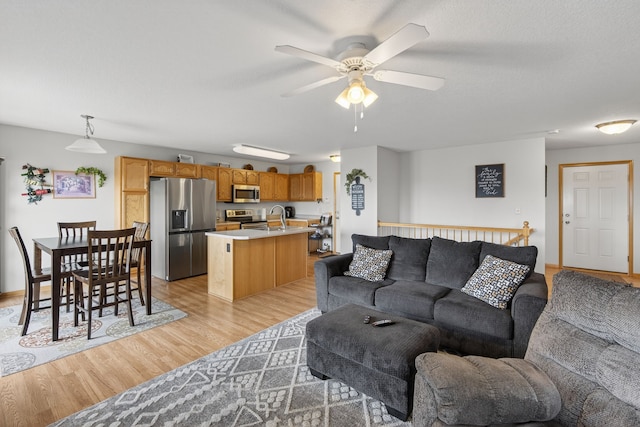 2618 13th St SW, Altoona, IA 50009 - living room with a ceiling fan and light wood-style flooring