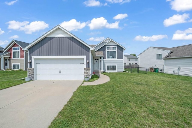 704 36th St SW, Bondurant, IA 50035 - view of front of home with board and batten siding, stone siding, driveway, and a garage