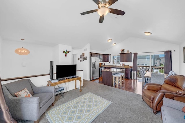 704 36th St SW, Bondurant, IA 50035 - living area featuring lofted ceiling, a ceiling fan, and dark wood-type flooring