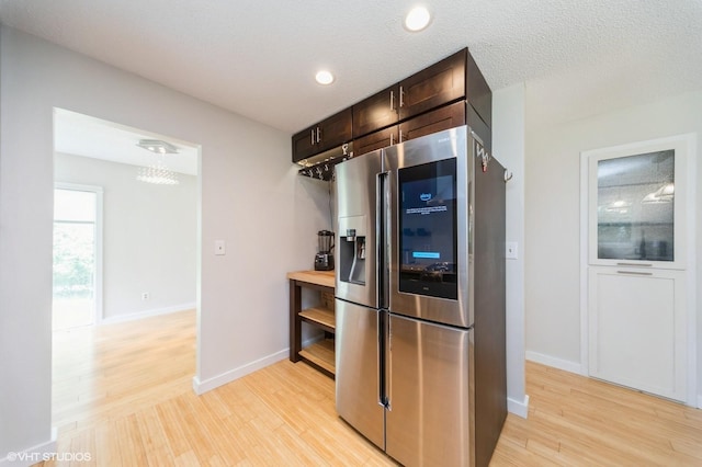 2729 Meadow Point Ct, West Des Moines, IA 50265 - kitchen with stainless steel fridge with ice dispenser, light wood finished floors, dark brown cabinets, and recessed lighting