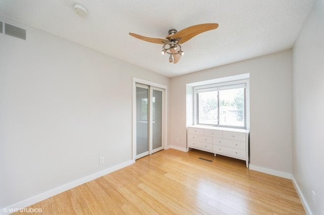 2729 Meadow Point Ct, West Des Moines, IA 50265 - unfurnished bedroom featuring light wood-style floors, a closet, and ceiling fan