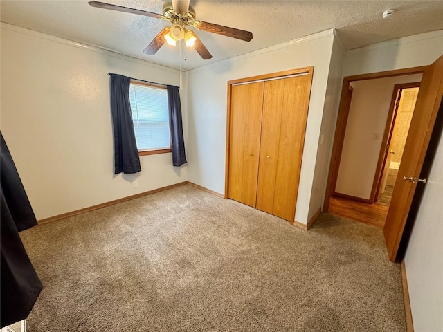 2611 E 38th St, Des Moines, IA 50317 - unfurnished bedroom with carpet flooring, a closet, crown molding, a textured ceiling, and ceiling fan