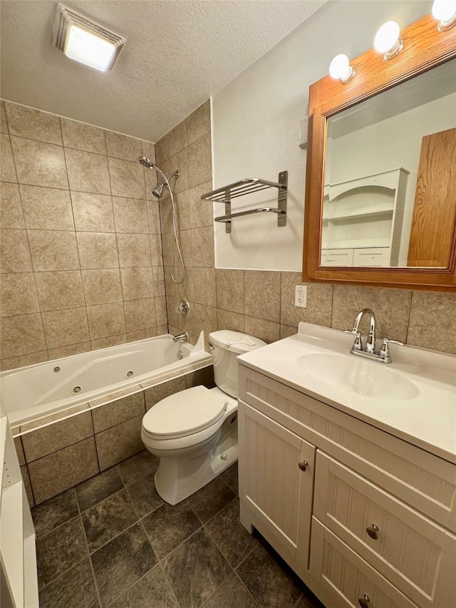 2611 E 38th St, Des Moines, IA 50317 - full bathroom with tile walls, a combined bath / shower with jetted tub, vanity, and a textured ceiling
