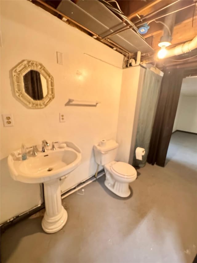 2611 E 38th St, Des Moines, IA 50317 - bathroom with concrete flooring and toilet