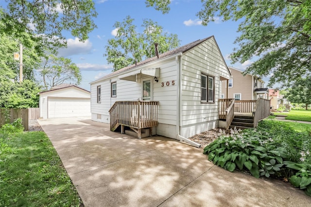 305 Hillside Ave, West Des Moines, IA 50265 - view of front of property featuring an outdoor structure, a detached garage, and a wooden deck