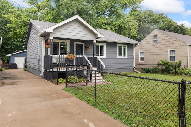 4034 6th Ave, Des Moines, IA 50313 - bungalow featuring a porch, an outdoor structure, a shingled roof, and a detached garage
