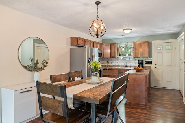 4034 6th Ave, Des Moines, IA 50313 - dining space with dark wood finished floors and a chandelier