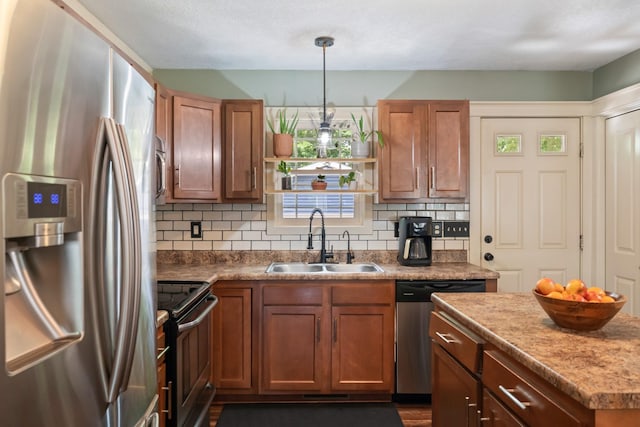 4034 6th Ave, Des Moines, IA 50313 - kitchen featuring appliances with stainless steel finishes, backsplash, decorative light fixtures, and brown cabinets