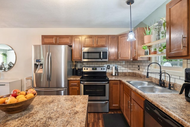 4034 6th Ave, Des Moines, IA 50313 - kitchen with stainless steel appliances, brown cabinetry, dark wood-style floors, and decorative backsplash