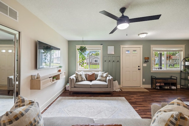 4034 6th Ave, Des Moines, IA 50313 - living area with wood finished floors, healthy amount of natural light, ceiling fan, and a textured ceiling