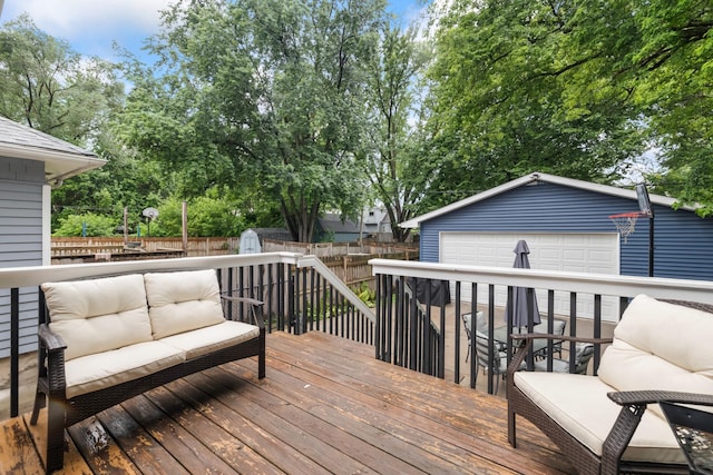 4034 6th Ave, Des Moines, IA 50313 - deck featuring outdoor lounge area, a fenced backyard, a garage, and a storage unit