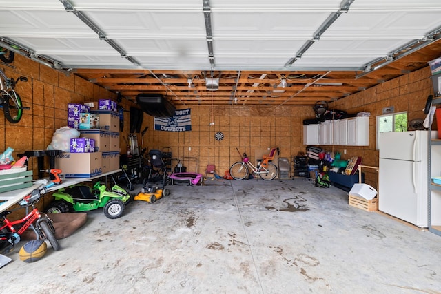 4034 6th Ave, Des Moines, IA 50313 - garage with freestanding refrigerator and a garage door opener