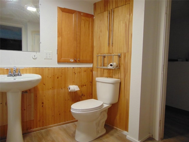 2340 Des Moines St, Des Moines, IA 50317 - bathroom featuring wood finished floors, wood walls, and a wainscoted wall