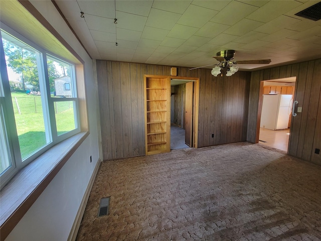 108 W Logan St, Casey, IA 50048 - empty room featuring wooden walls, a ceiling fan, and carpet