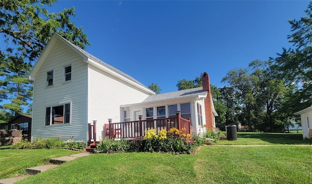 108 W Logan St, Casey, IA 50048 - rear view of property featuring a wooden deck, a yard, and a chimney