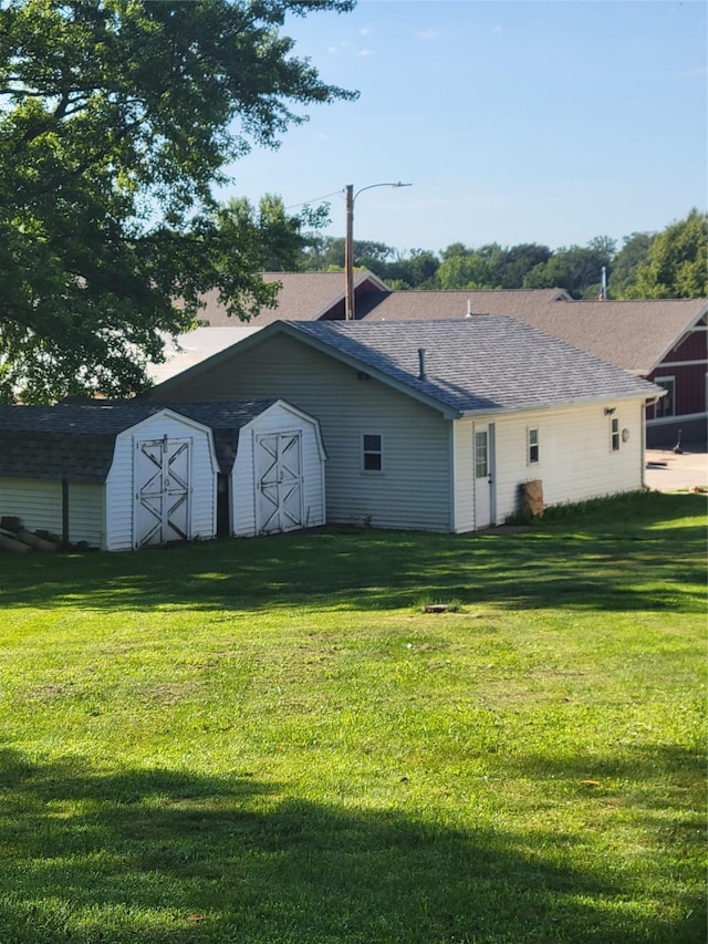 108 W Logan St, Casey, IA 50048 - rear view of house featuring a storage shed and a lawn
