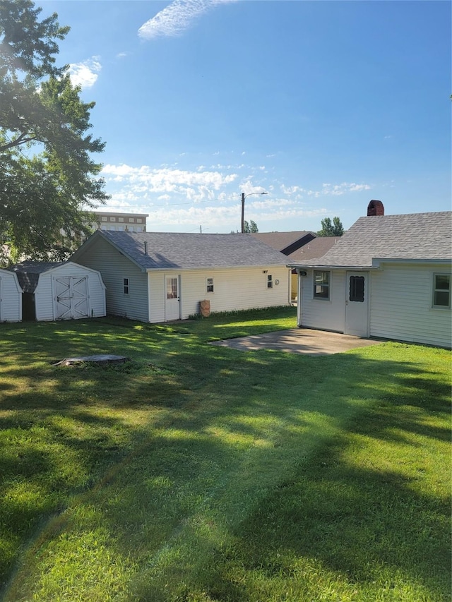 108 W Logan St, Casey, IA 50048 - view of grassy yard featuring a shed and a patio area