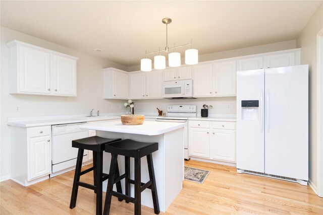 7316 SE 23rd St Unit 5, Des Moines, IA 50320 - kitchen featuring white appliances, white cabinets, light countertops, and light wood-type flooring