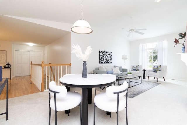 7316 SE 23rd St Unit 5, Des Moines, IA 50320 - dining area with vaulted ceiling, ceiling fan, and light colored carpet