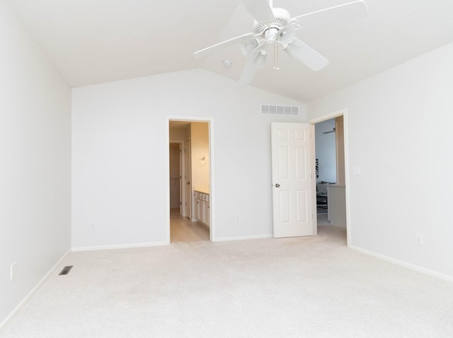 7316 SE 23rd St Unit 5, Des Moines, IA 50320 - unfurnished bedroom featuring light colored carpet, vaulted ceiling, connected bathroom, and ceiling fan