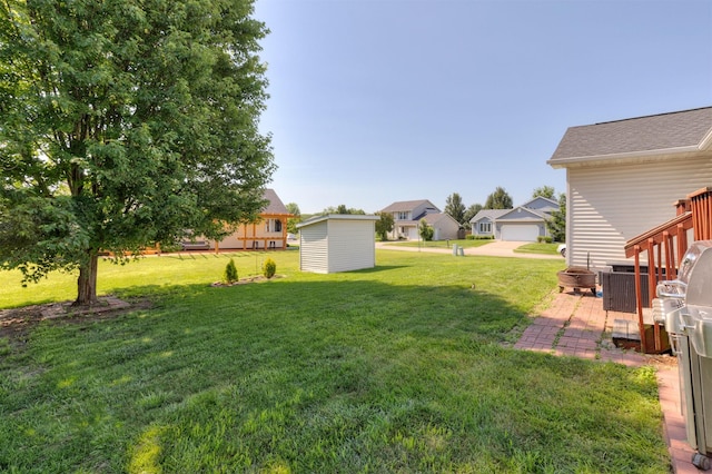 2609 Eagle Point Ct, Des Moines, IA 50320 - view of green lawn featuring a storage unit and a residential view