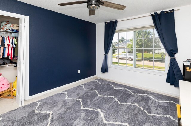 2609 Eagle Point Ct, Des Moines, IA 50320 - unfurnished bedroom with carpet, a closet, a textured ceiling, and ceiling fan