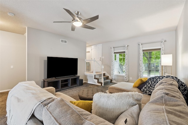 263 SE Booth Ave, Waukee, IA 50266 - living room with carpet floors, ceiling fan, and stairway